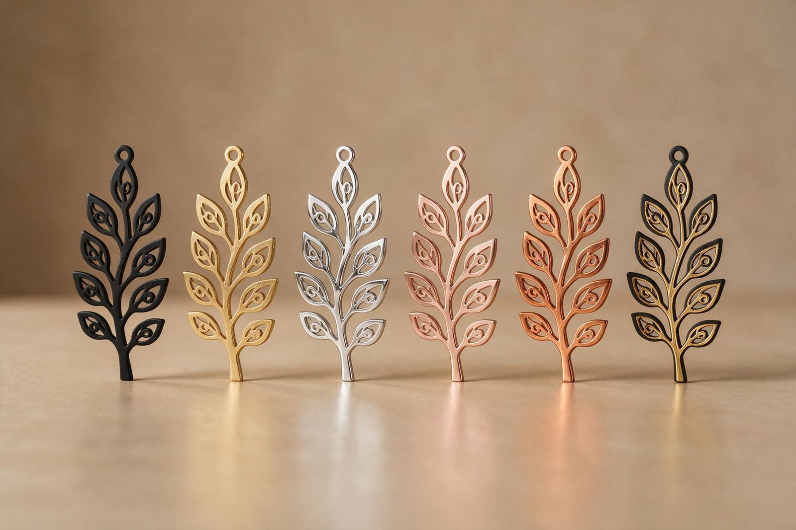 The same leaf design cut in six metal finishes in a row